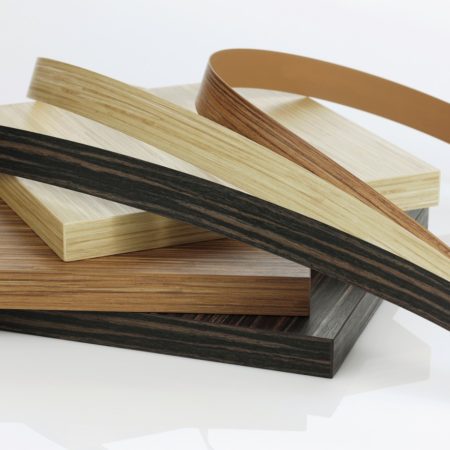 Photo of three samples of PVC Edgebanding on top of three boards with each edgebanding installed.